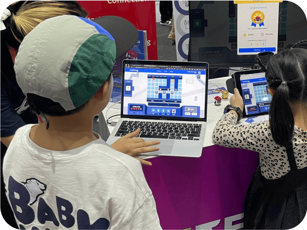 Kids celebrating success after completing programming challenges